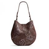 Sepia Large | Model holding round leather purse with adjustable shoulder strap