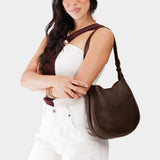 Coldbrew Medium | Woman wearing rounded shoulder bag with adjustable strap on a white background