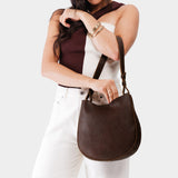 Coldbrew Medium | Woman wearing rounded shoulder bag with adjustable strap on a white background