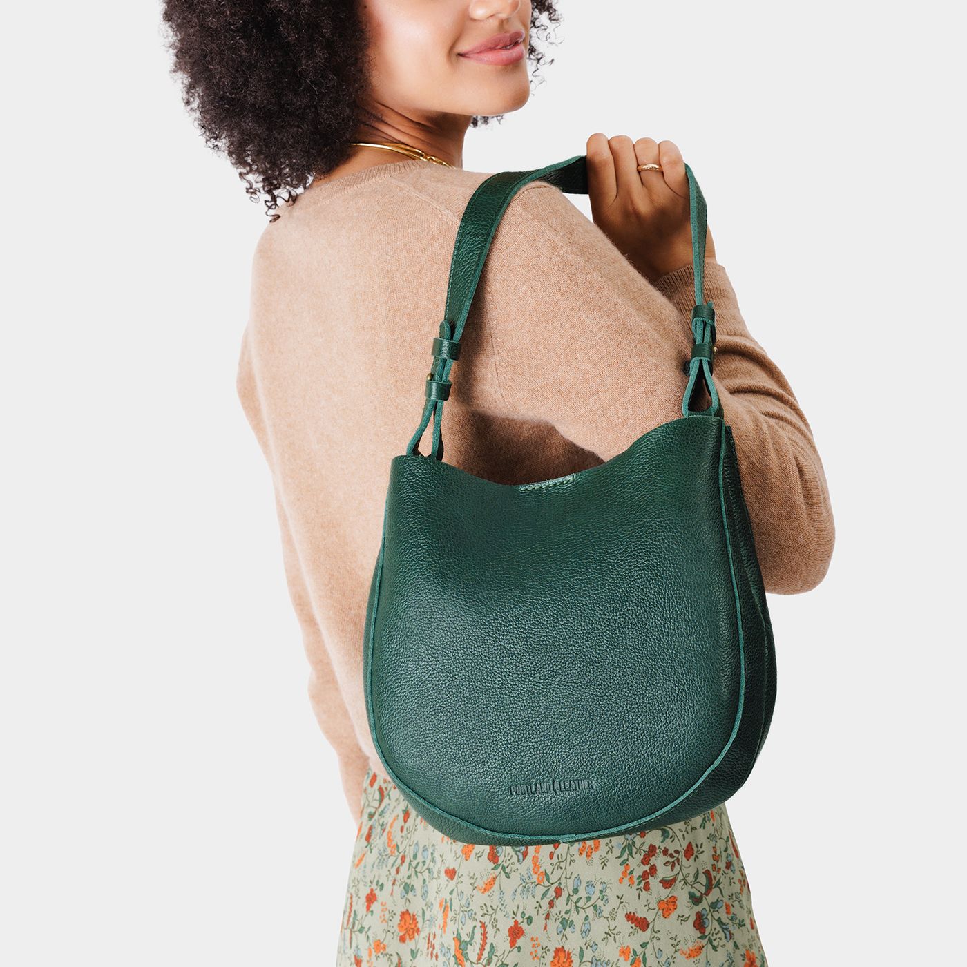 Forest Green*Medium | Woman wearing rounded shoulder bag with adjustable strap on a white background