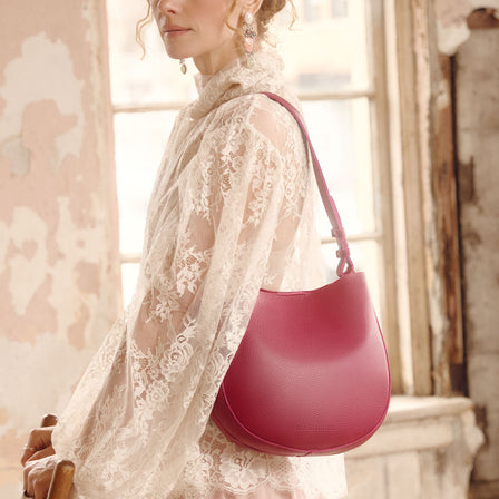 Orchid*Medium | Rounded shoulder bag with adjustable strap on a white background