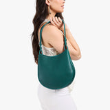 Sea Glass Medium | Model carrying round leather purse with adjustable shoulder strap