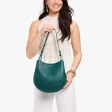 Sea Glass Medium | Model holding round leather purse with adjustable shoulder strap