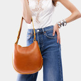 Sienna Medium | Woman wearing rounded shoulder bag with adjustable strap on a white background