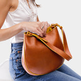 Sienna Medium | Woman wearing rounded shoulder bag with adjustable strap on a white background