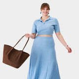 Stagecoach Oversized | Model holding a  leather tote bag 