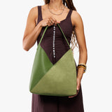 Dryland Green Oversized | Model holding large shoulder bag with adjustable strap and magnetic snap closure