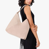 Toasted Oat Oversized | Model carrying large shoulder bag with adjustable strap and magnetic snap closure