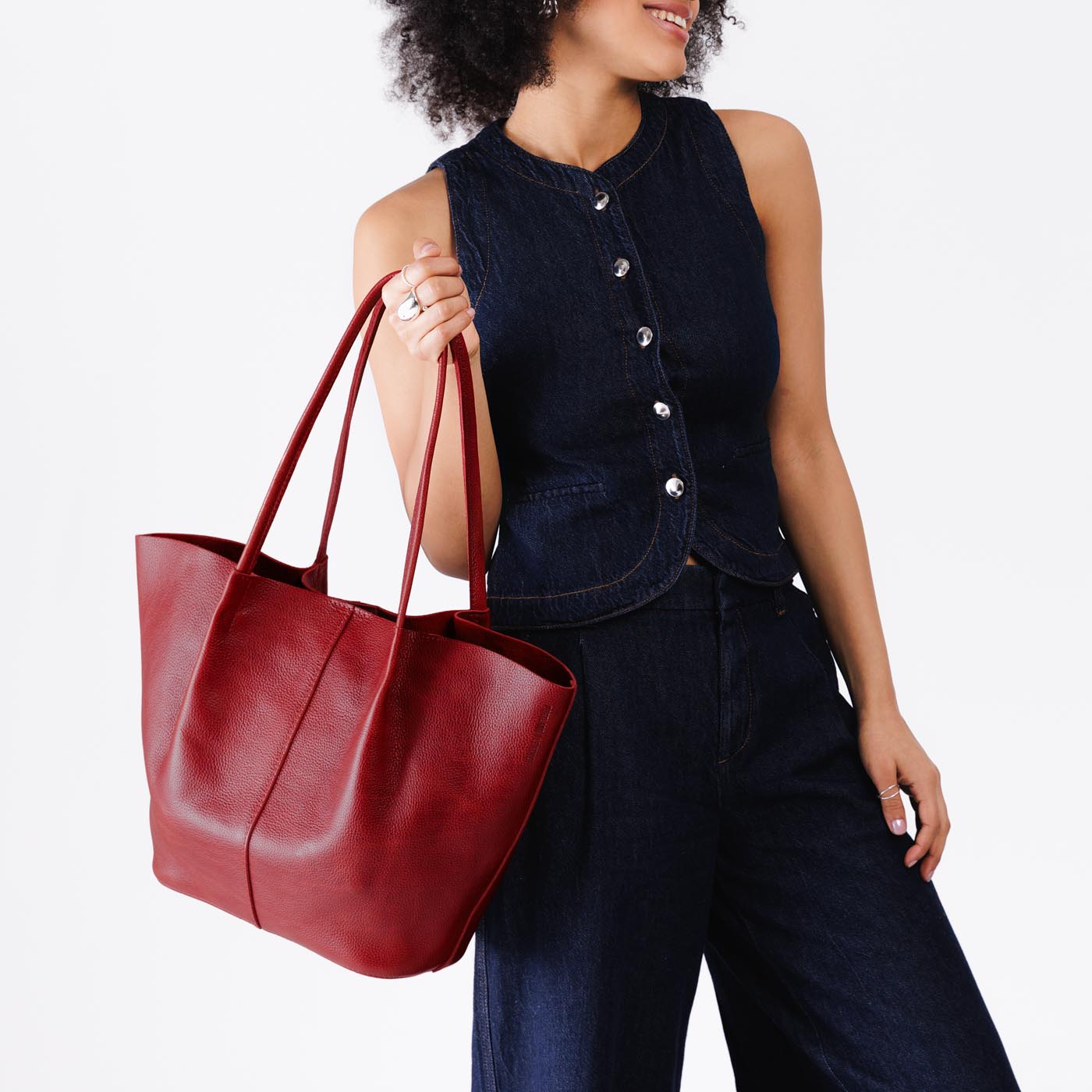 Chili Red*Oversized | Model holding extra wide bucket shaped tote bag with matching leather handles