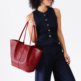 Chili Red Oversized | Model holding extra wide bucket shaped tote bag with matching leather handles