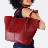 Chili Red Oversized | Model holding extra wide bucket shaped tote bag with matching leather handles