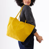 Hello Yellow Oversized | Model holding extra wide bucket shaped tote bag with matching leather handles