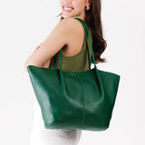 Bacalar Oversized | Model holding extra wide bucket shaped tote bag with matching leather handles