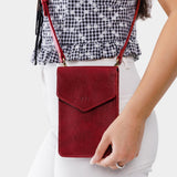 Chili Red | Model wearing slim, phone-shaped crossbody purse with magnetic closure