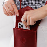 Chili Red | Model wearing slim, phone-shaped crossbody purse with magnetic closure