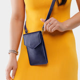 Cobalt | Model wearing slim, phone-shaped crossbody purse with magnetic closure