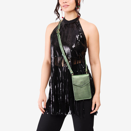 Metallic Greench | Model wearing slim, phone-shaped crossbody purse with magnetic closure