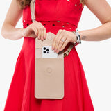 Oatmilk | Model wearing slim, phone-shaped crossbody purse with magnetic closure