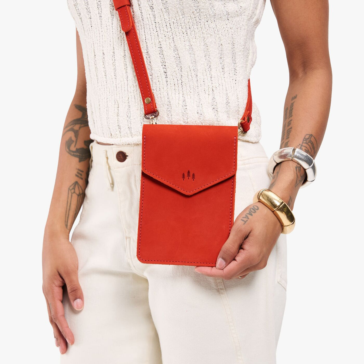 Paprika | Model carrying slim, phone-shaped crossbody purse with magnetic closure