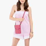 Wild Rose | Model wearing slim, phone-shaped crossbody purse with magnetic closure