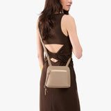 All Variants | A model wearing a Small luna Crossbody