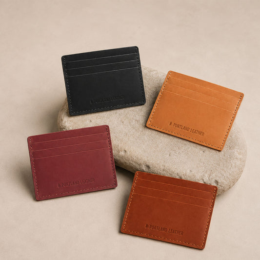 Toscano | Group of wallets displayed on a light colored stone
