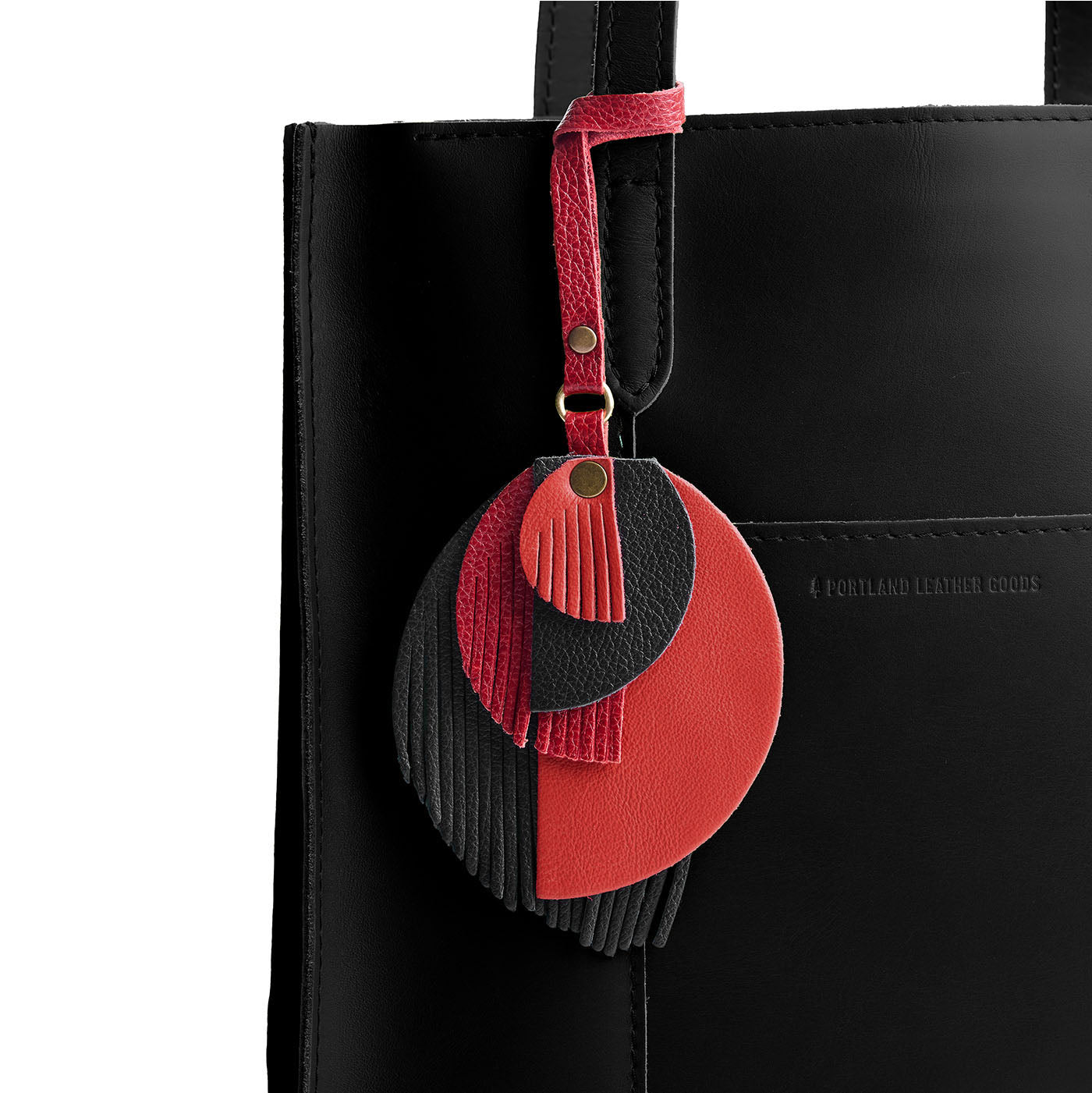 Poison | Intricately cut leather shapes and fringe