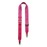 Pink Punk | Leather and webbing strap with repeating PLG lettering on a white background
