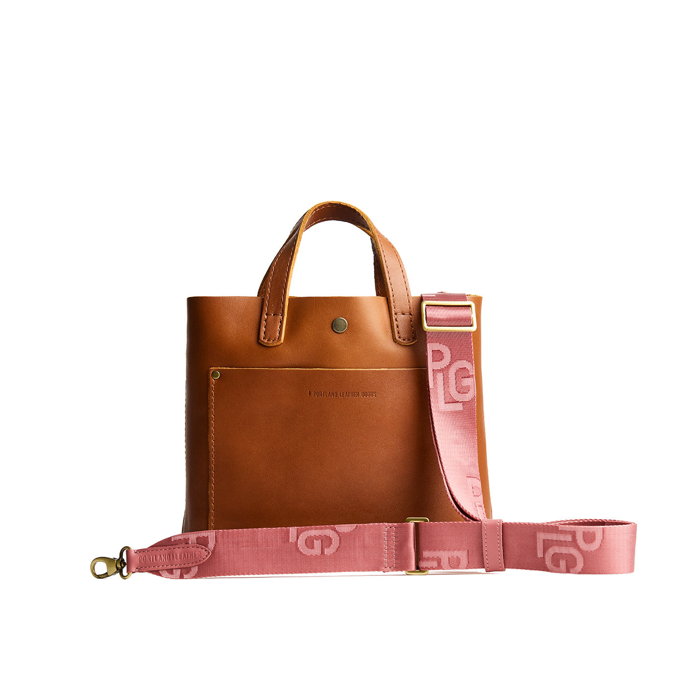 Petal Glow | Pink strap with repeating PLG letter pattern and brass-toned hardware