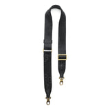 Black | Black strap with repeating PLG letter pattern and brass-toned hardware