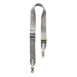 Stone Mist | Grey strap with repeating PLG letter pattern and brass-toned hardware