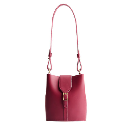 Berry Good | Leather bucket shoulder bag with adjustable strap and magnetic closure on a white background