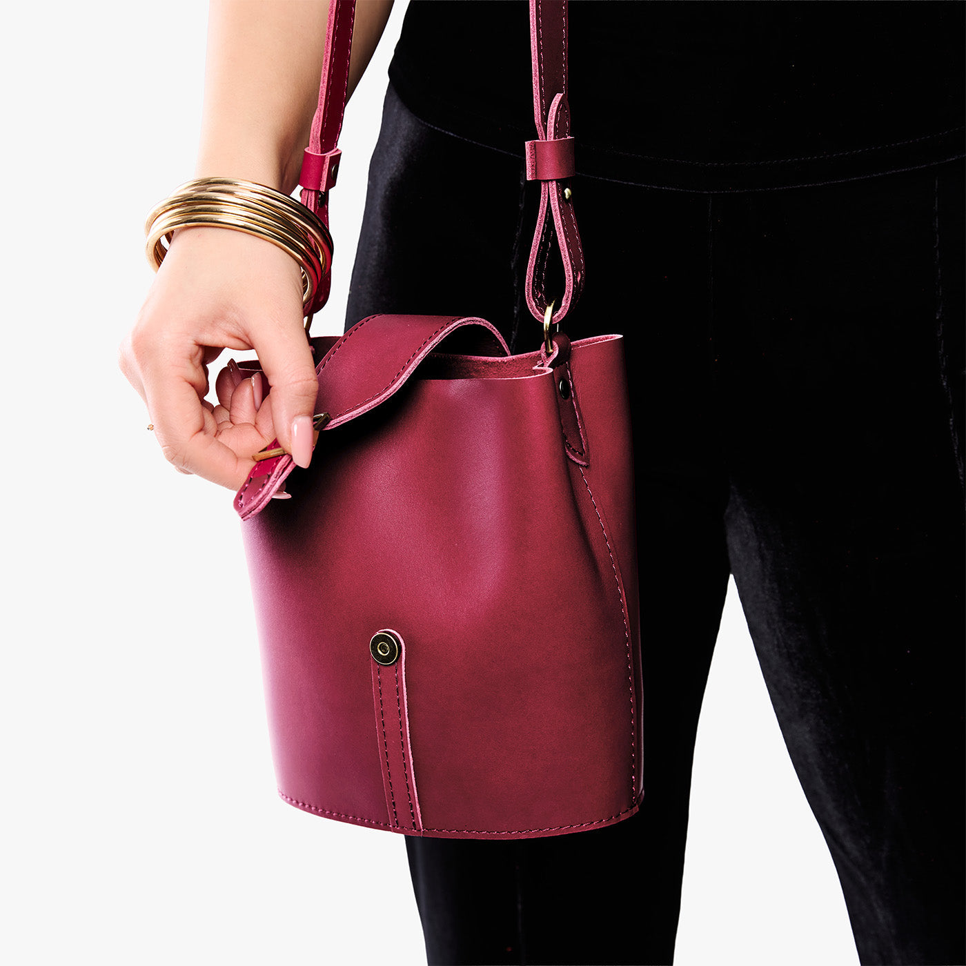 Berry Good | Model wearing leather bucket shoulder bag with adjustable strap and magnetic closure 