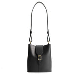 Black | Leather bucket shoulder bag with adjustable strap and magnetic closure on a white background