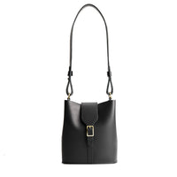 Black | Leather bucket shoulder bag with adjustable strap and magnetic closure on a white background