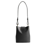 Black | Leather bucket shoulder bag with adjustable strap and magnetic closure on a white background