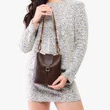 Coldbrew | Model wearing leather bucket shoulder bag with adjustable strap and magnetic closure 