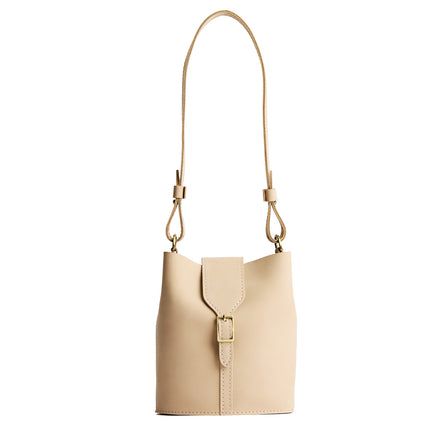 Dragon Bone | Leather bucket shoulder bag with adjustable strap and magnetic closure on a white background
