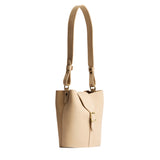Dragon Bone | Leather bucket shoulder bag with adjustable strap and magnetic closure on a white background