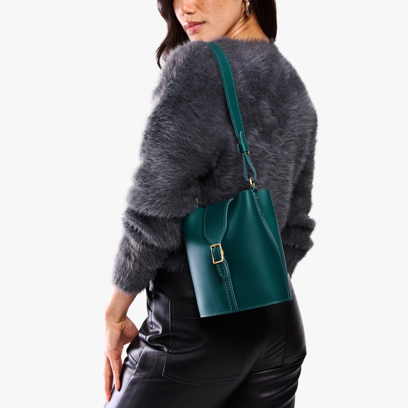 Harbor | Model wearing leather bucket shoulder bag with adjustable strap and magnetic closure 