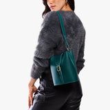 Harbor | Model wearing leather bucket shoulder bag with adjustable strap and magnetic closure 