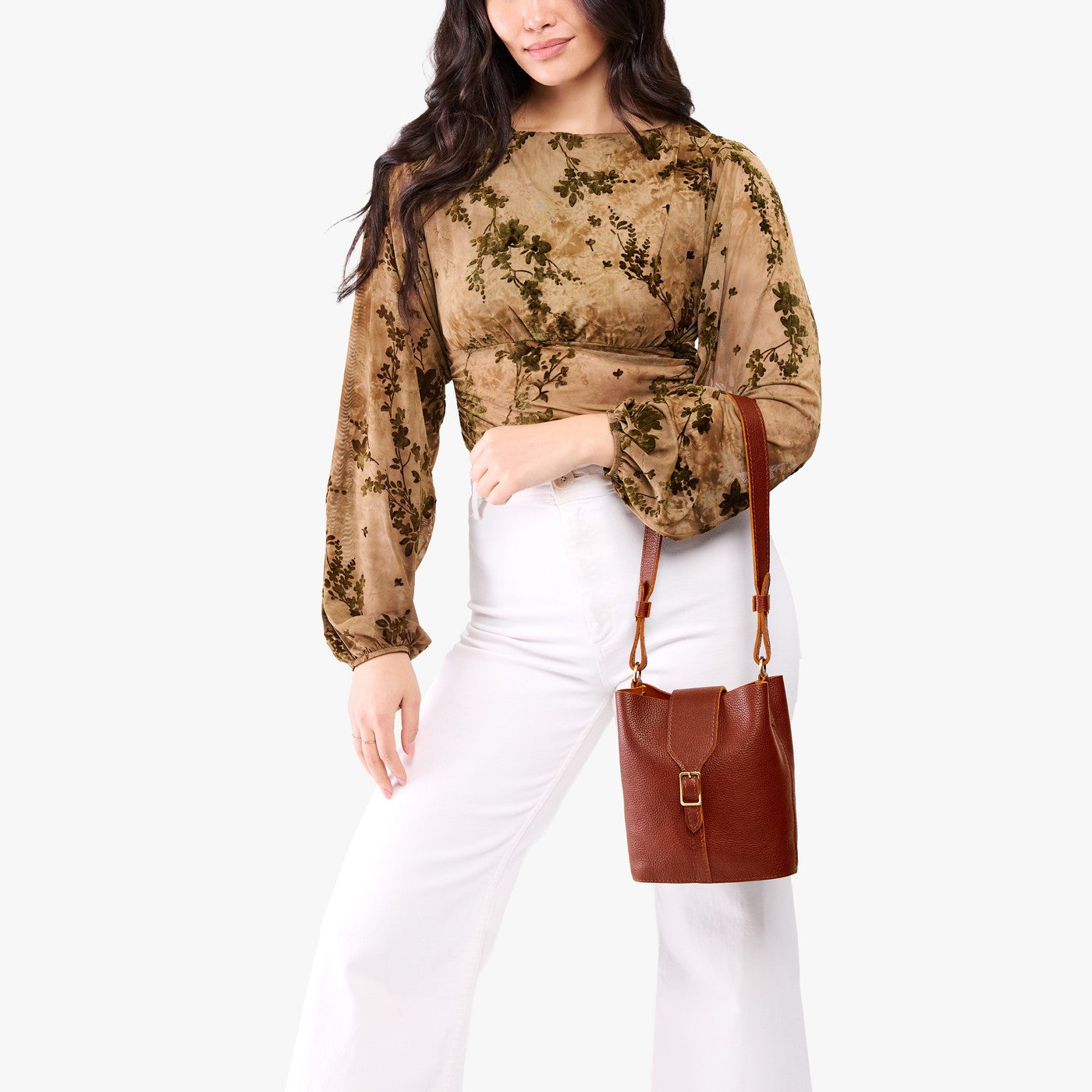 Nutmeg | Model wearing leather bucket shoulder bag with adjustable strap and magnetic closure 