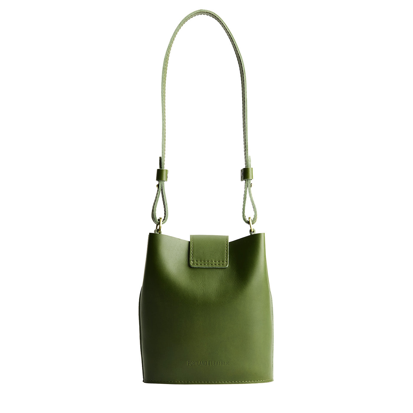 Pine | Leather bucket shoulder bag with adjustable strap and magnetic closure on a white background