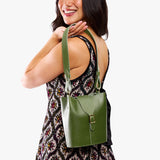 Pine | Model wearing leather bucket shoulder bag with adjustable strap and magnetic closure