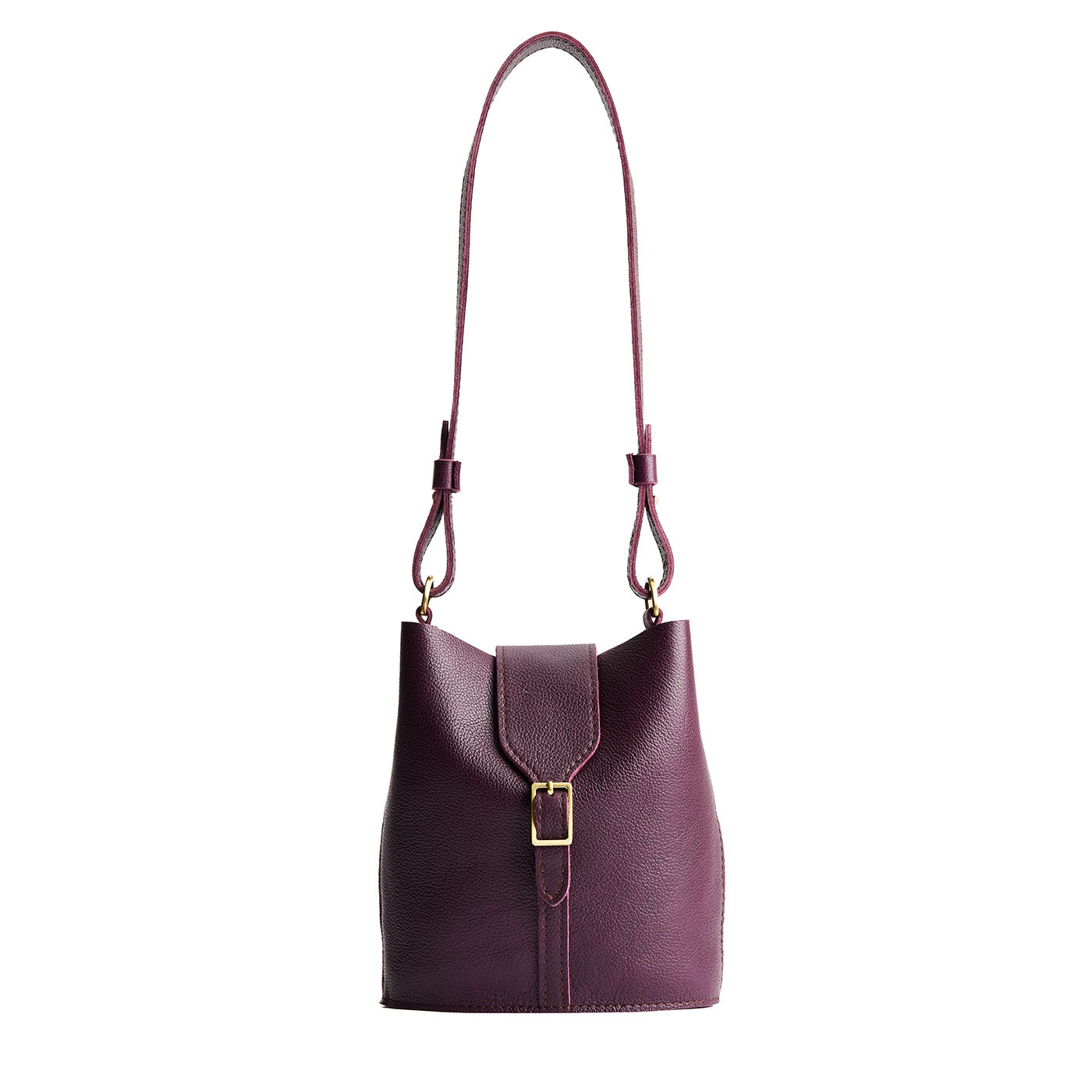 Plum | Leather bucket shoulder bag with adjustable strap and magnetic closure on a white background