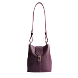 Plum | Leather bucket shoulder bag with adjustable strap and magnetic closure on a white background