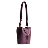 Plum | Leather bucket shoulder bag with adjustable strap and magnetic closure on a white background