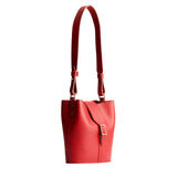 Ruby | Leather bucket shoulder bag with adjustable strap and magnetic closure on a white background