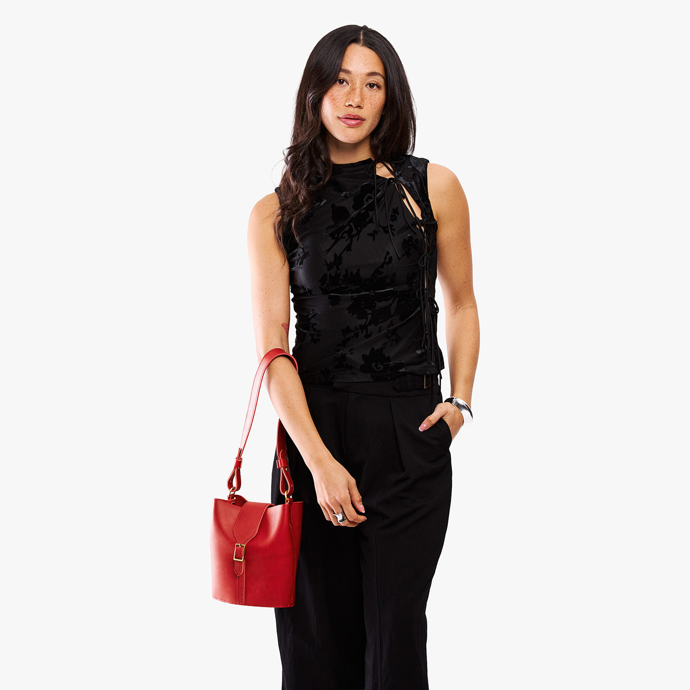 Ruby | Model wearing leather bucket shoulder bag with adjustable strap and magnetic closure