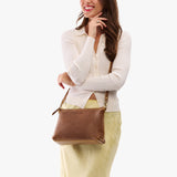 Asheville Large | Model wearing a zip top crossbody bag with detachable strap